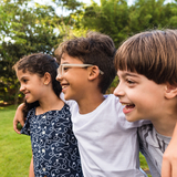 Three school-age children play together outside
